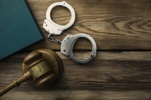 handcuffs and gavel on desk