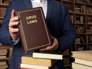 lawyer holding book on drug laws