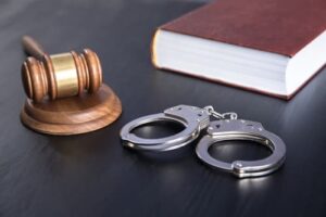 book with handcuffs and gavel