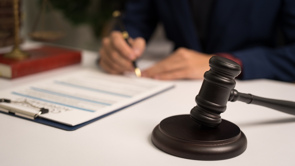 Male lawyer working with law book, A legal binding, Unilateral contract,